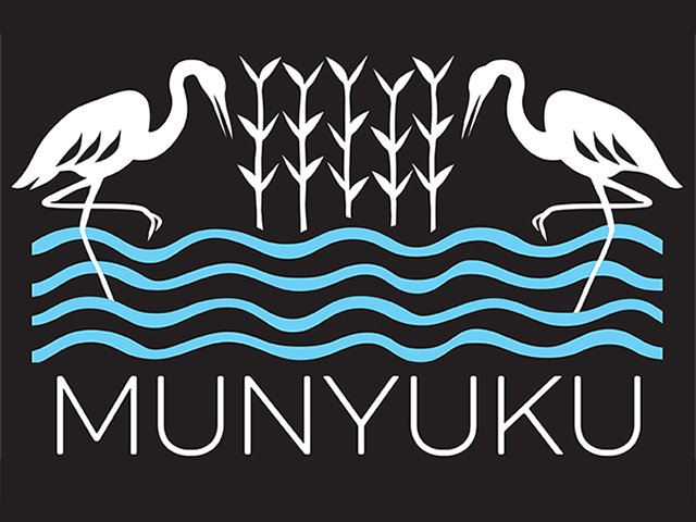 The Munyuku trust logo shows 2 wading birds in the water flanking growing plants